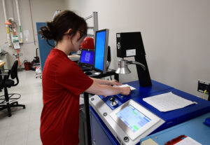 Student researcher running a test on the TSI 8130 A.