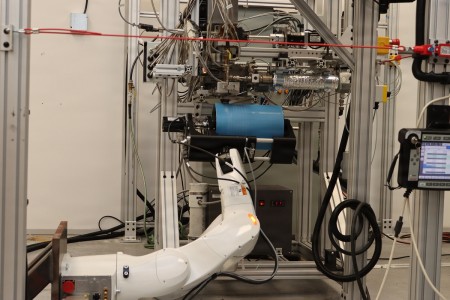 The melt spinner arm moves into place and custom-sized fibers are deposited onto a spinning drum, quickly creating a broad swath of non-woven material used in products such as masks.